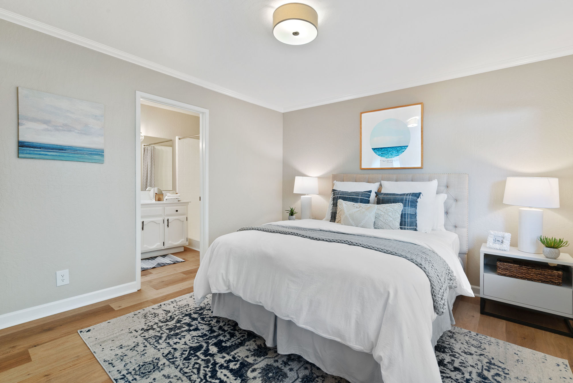 Master bedroom in neutral colors and blue accents